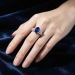 wearing lab grown oval blue sapphire pave ring S925 sterling silver on hand model