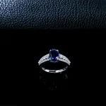 close up detail of lab grown oval blue sapphire pave ring S925 sterling silver four prong setting