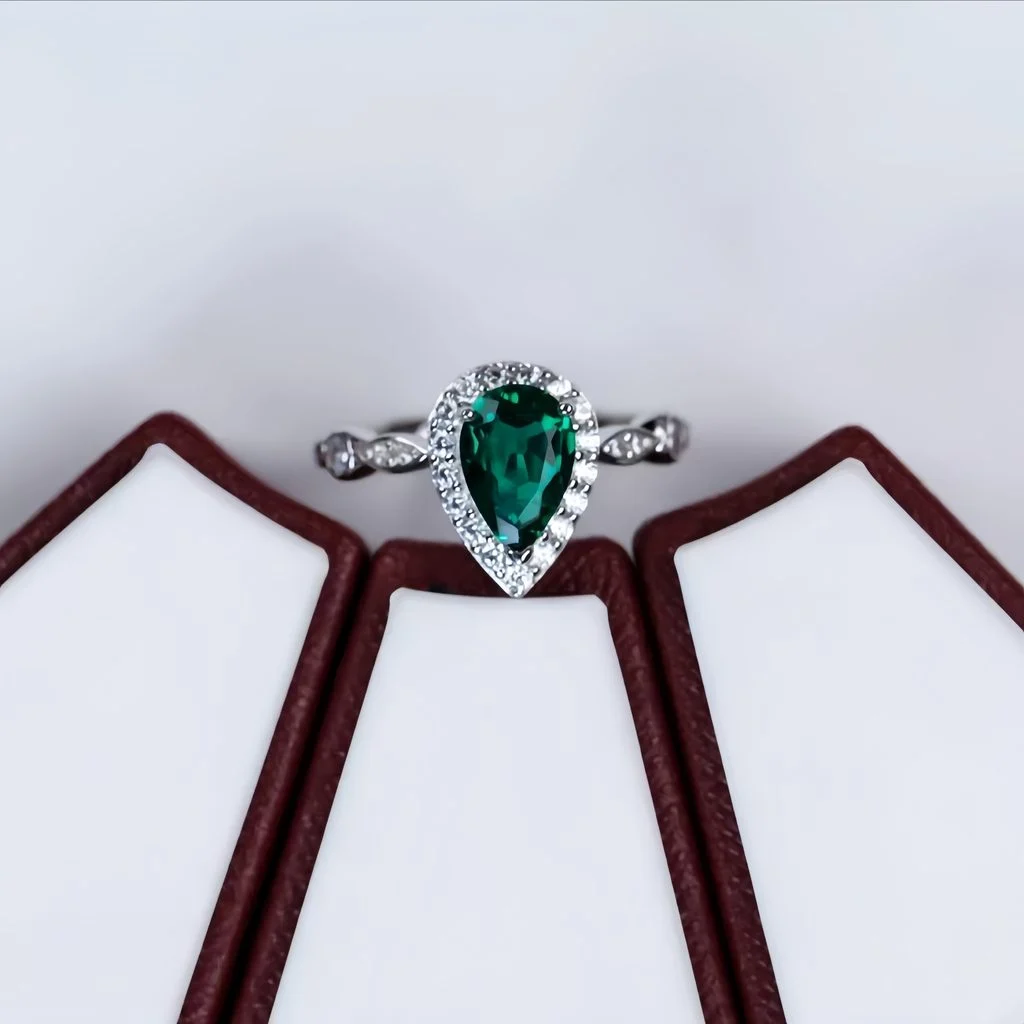 top view lab grown emerald green pear diamond halo ring flat lay S925 sterling silver