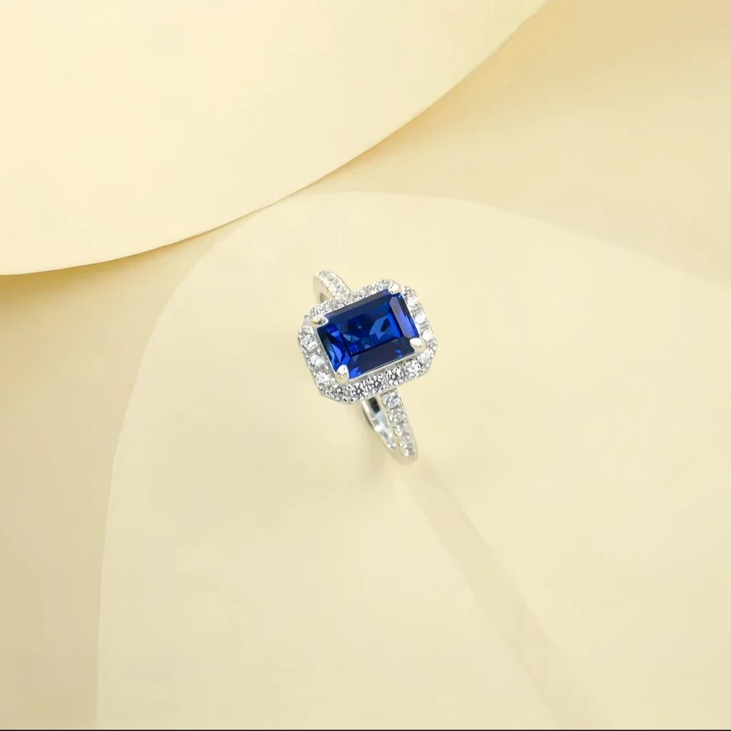 close up detail of lab grown square halo blue diamond ring S925 sterling silver accent stones