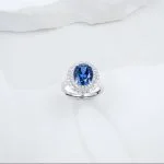 wearing lab grown flat oval halo blue diamond ring S925 sterling silver on hand model