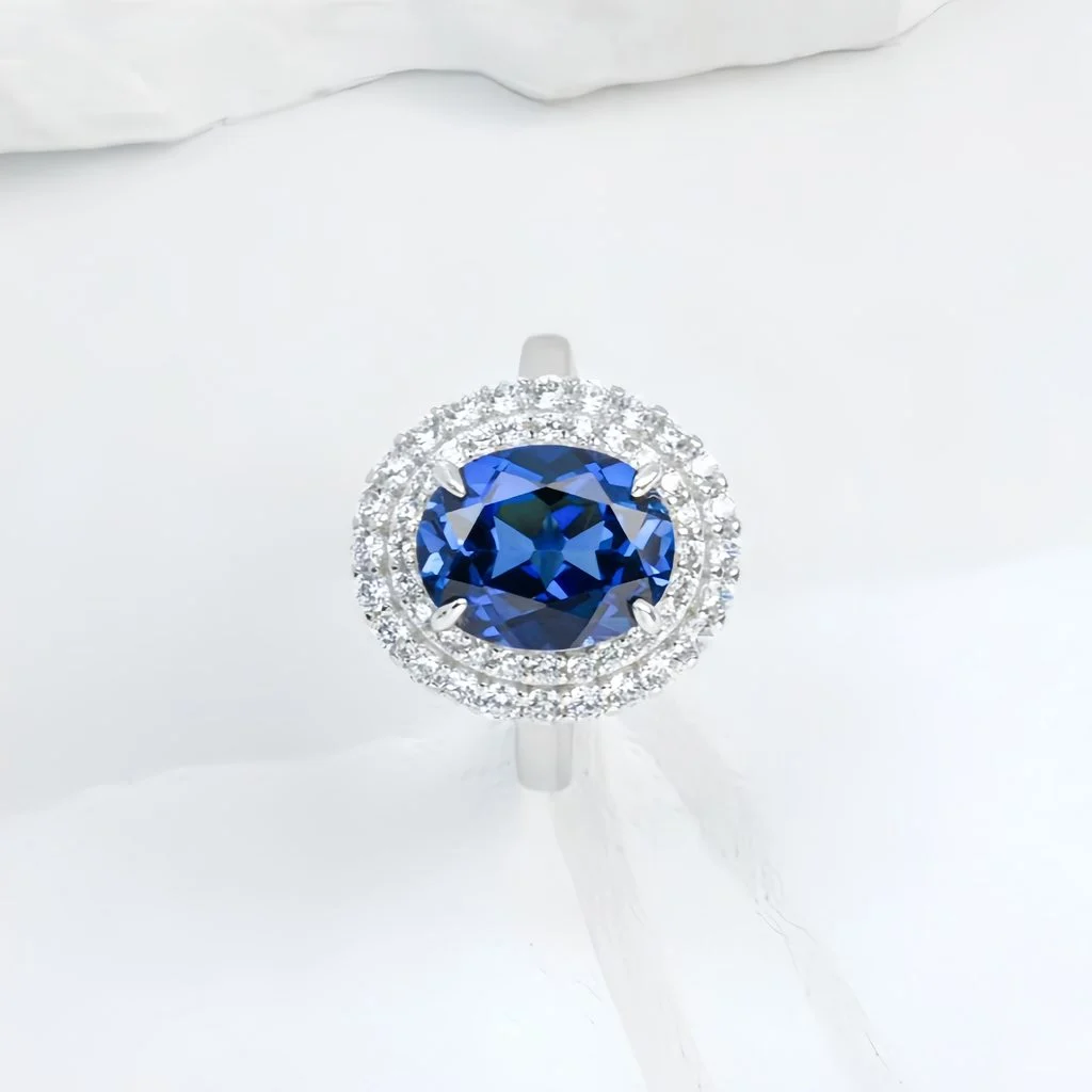 wearing lab grown flat oval halo blue diamond ring S925 sterling silver on hand model