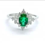lab grown vintage crown emerald ring S925 sterling silver detail close-up oval cut green gemstone baguette round diamond accents crown prong setting