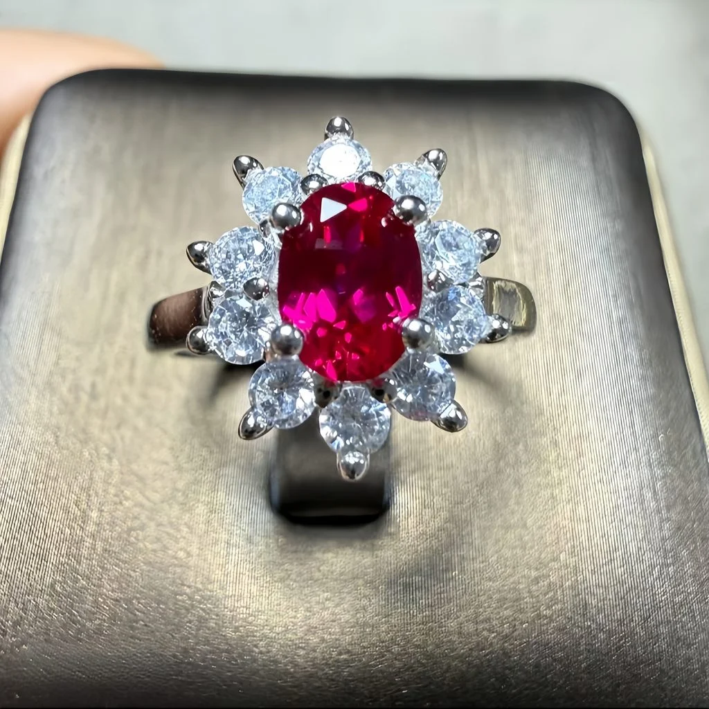 lab grown pigeon blood ruby Diana halo ring S925 sterling silver detail close-up oval cut red gemstone round diamond cluster halo prong setting