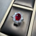 lab grown sunflower halo ruby ring S925 sterling silver detail close-up oval cut red gemstone pear shaped diamond accents prong setting floral design