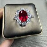 lab grown sunflower halo ruby ring S925 sterling silver worn on hand finger oval cut red gemstone pear shaped diamond accents adjustable band
