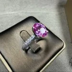 lab grown padparadscha sapphire oval ring S925 sterling silver detail close-up pavé halo setting lotus pink orange gemstone facets