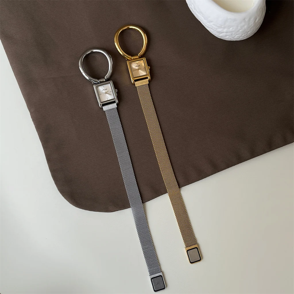 Vintage square watch for women in gold and silver, showing oversized ring loop and magnetic mesh strap