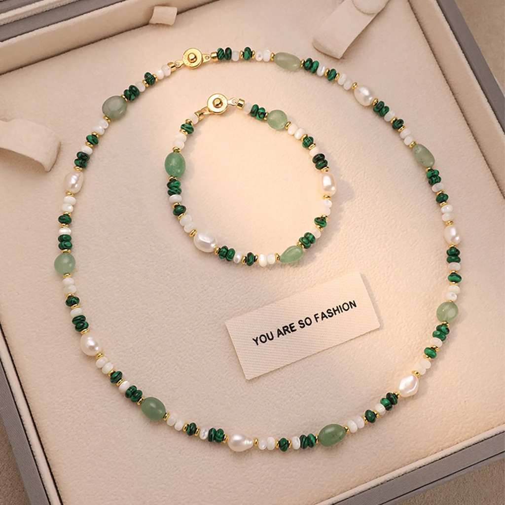 Natural freshwater pearl and crystal beaded necklace and bracelet set displayed together in luxury gift box, featuring 6-7mm baroque pearls, malachite chips, aventurine ovals, and 18K gold-plated hardware on cream suede interior by MAISON ELARA & CO