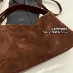 Model carrying navy genuine leather buckle hobo tote bag, everyday commute outfit look