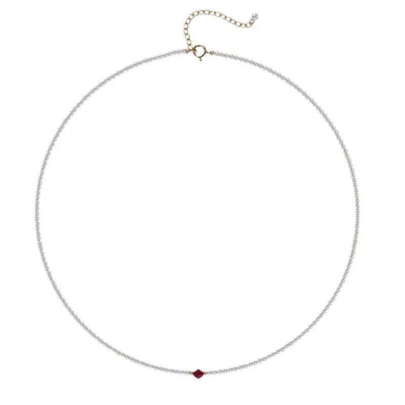 Model wearing dainty Swarovski pearl choker necklace with wine-red zirconia accent on collarbone