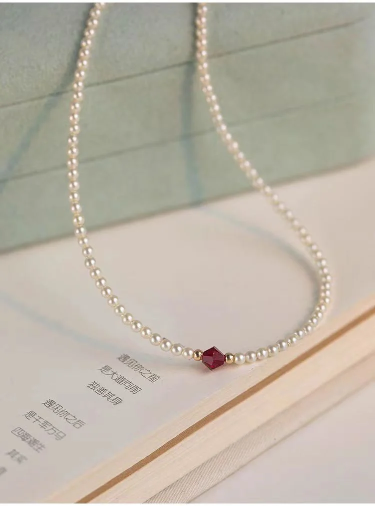 Elegant Swarovski pearl choker necklace styled in mint green jewelry box with book, lifestyle photography