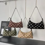 Polka dot suede hobo bags displayed hanging in four colors - black, coffee brown, olive green, beige