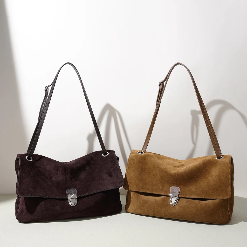 Two genuine leather shoulder bags displayed side by side in coffee brown and camel tan colorways, showing identical soft unstructured silhouette with vintage silver push-lock clasp and adjustable leather straps