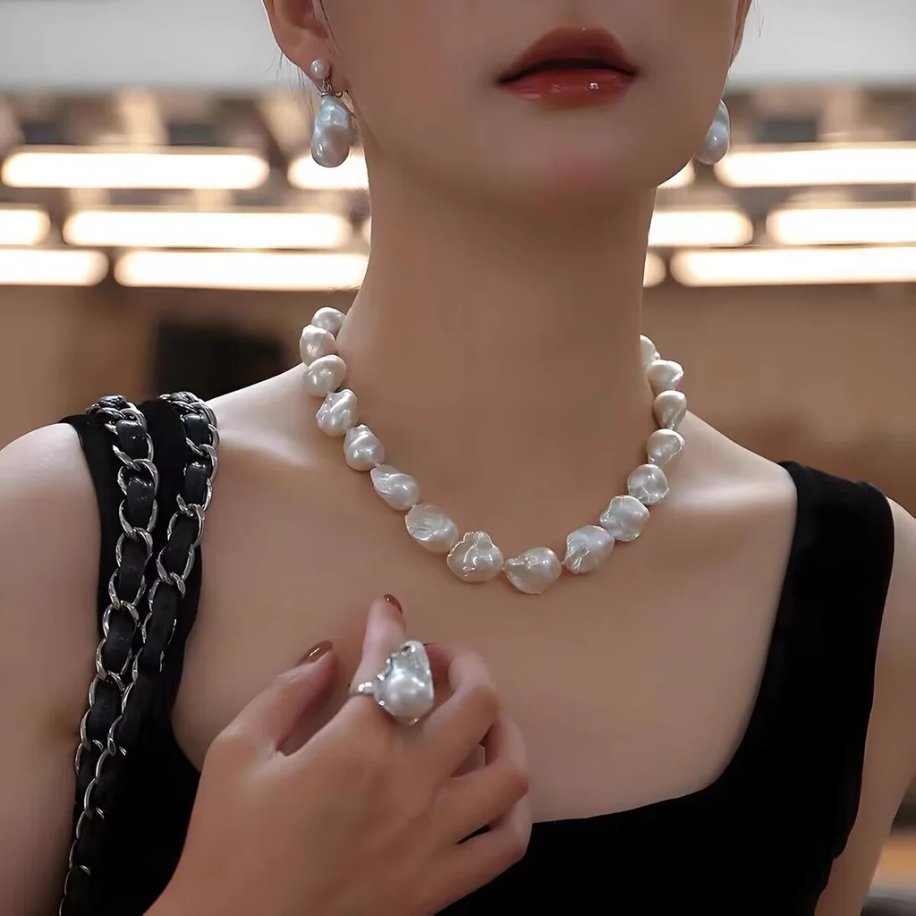 Model wearing large baroque pearl necklace, natural freshwater irregular statement jewelry