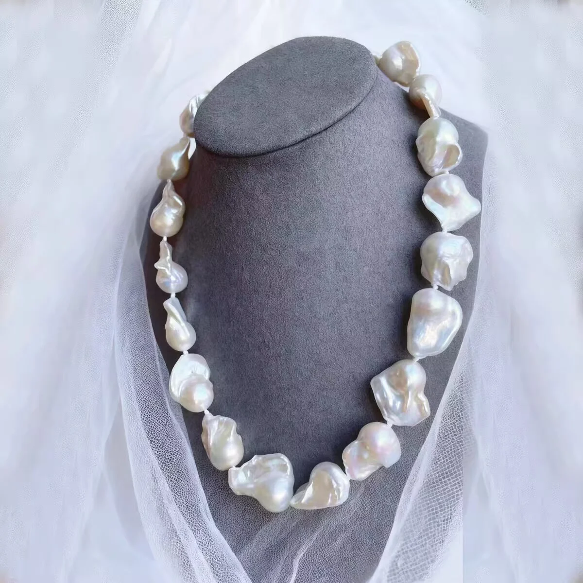 Large baroque pearl necklace on gray jewelry bust, natural freshwater irregular statement pearls by MAISON ELARA & CO
