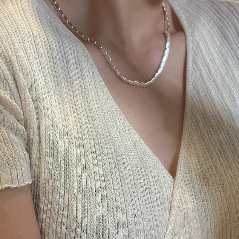 S925 sterling silver brushed bean necklace worn by model with beige knit top, Korean minimalist jewelry