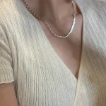 Model wearing S925 sterling silver brushed bean necklace with beige knit top, minimalist Korean style jewelry