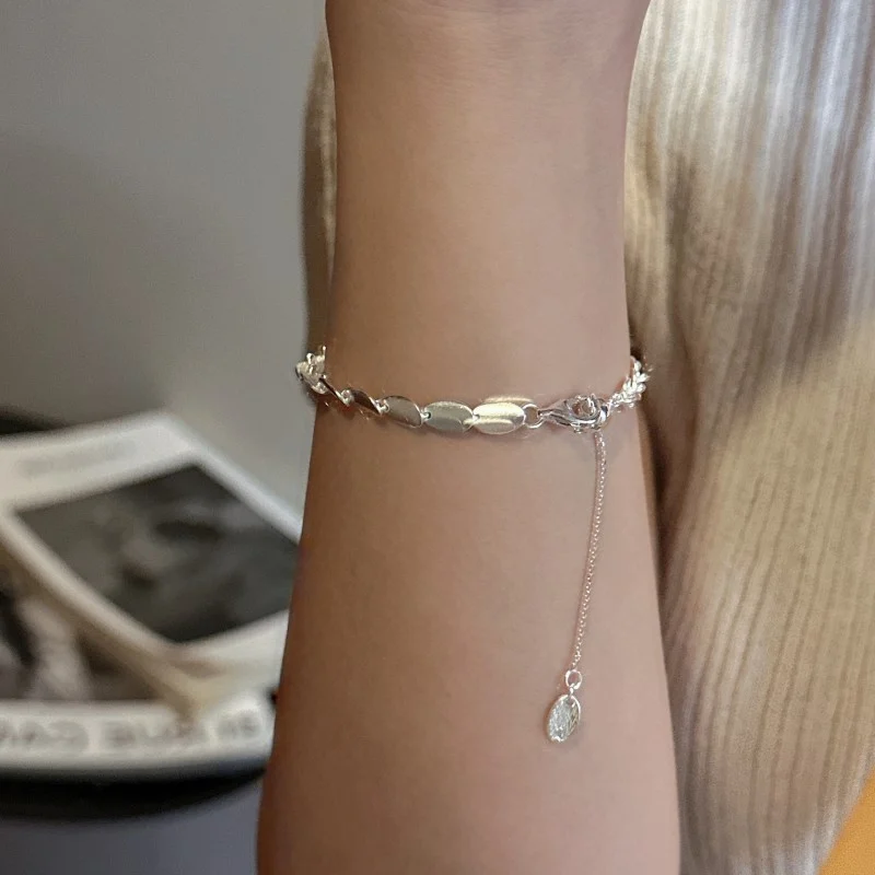 S925 sterling silver brushed bean jewelry worn on wrist, versatile minimalist accessory styling