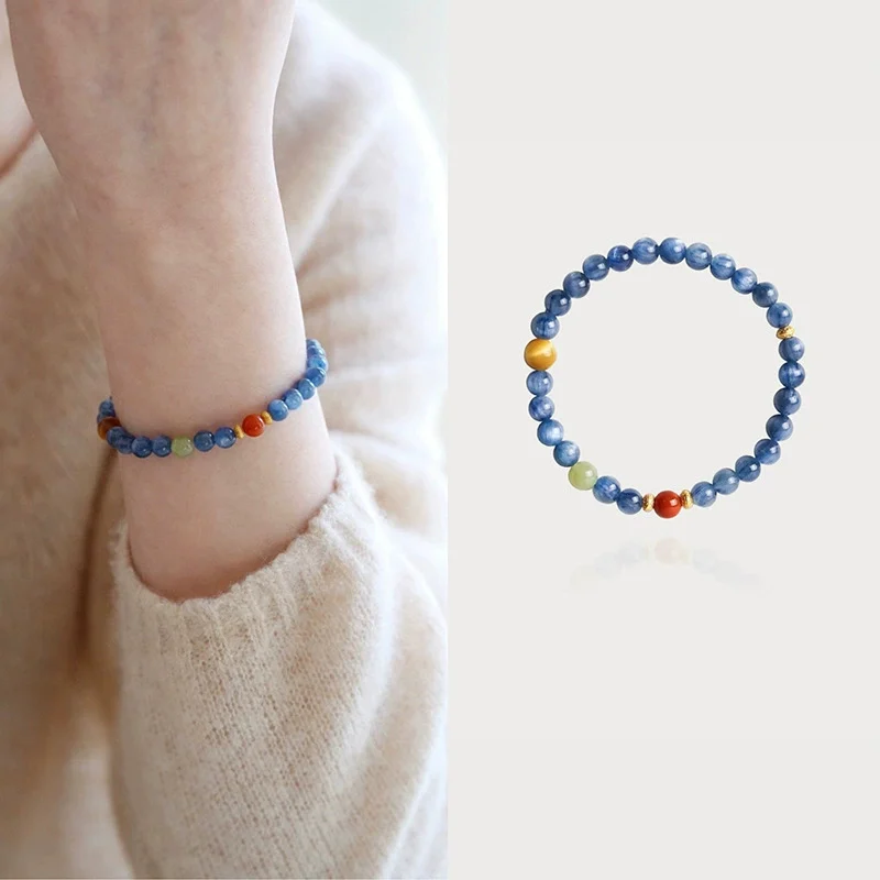 Blue crystal beaded bracelet worn on the wrist with a knit sweater sleeve