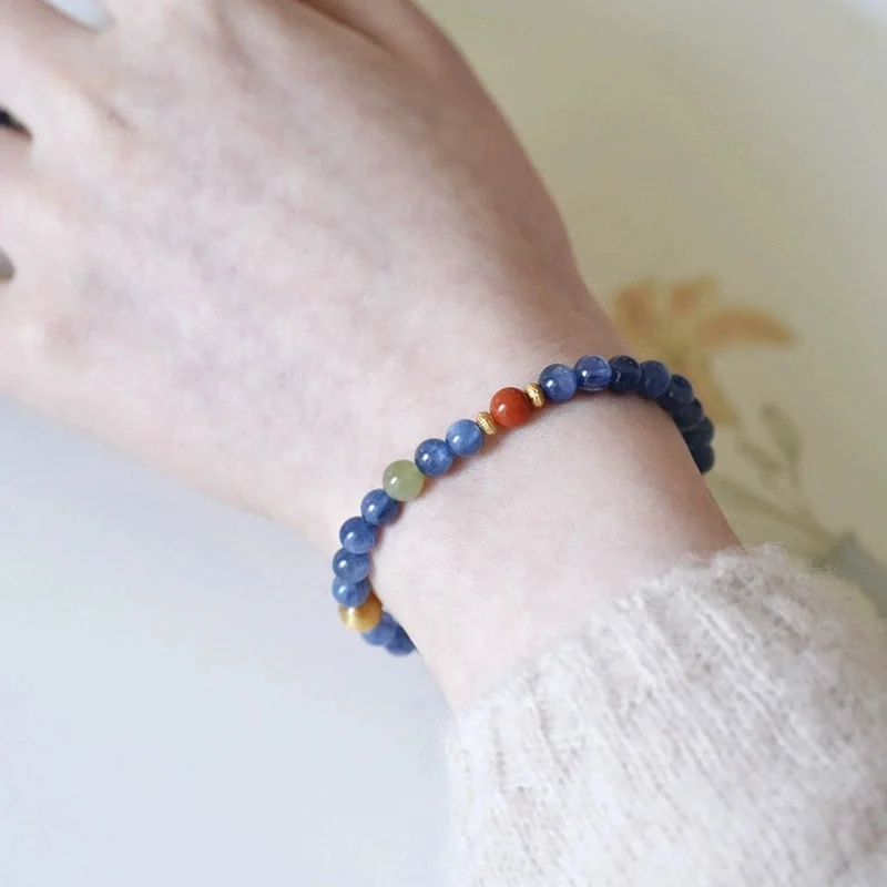 Close flat lay of blue crystal and South Red agate bead order with gold tone spacers
