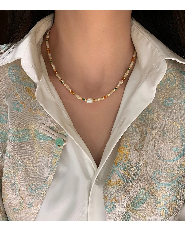 Close up of the natural stone and shell beaded necklace showing bead texture and color