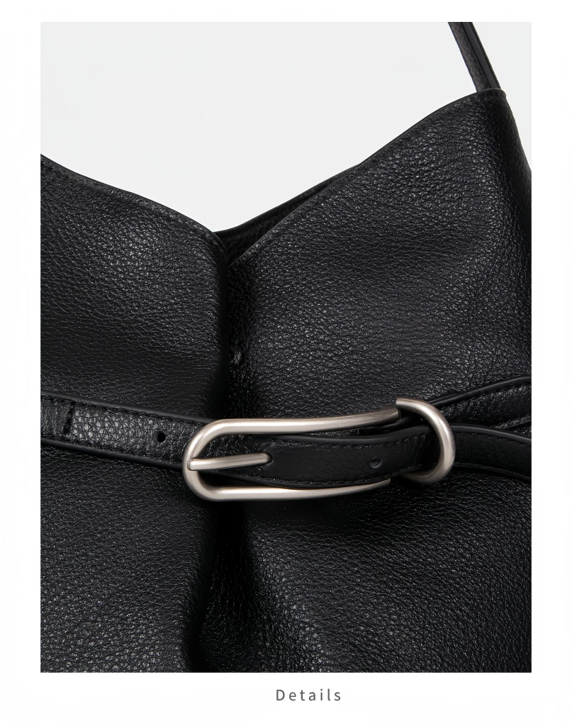 Close‑up view of metal buckle lock detail on oversized top‑grain cowhide bucket bag