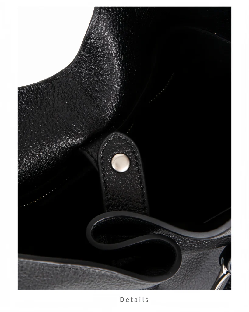 Interior close‑up view of oversized top‑grain leather bucket bag, showing inner structure and strap rivet detail