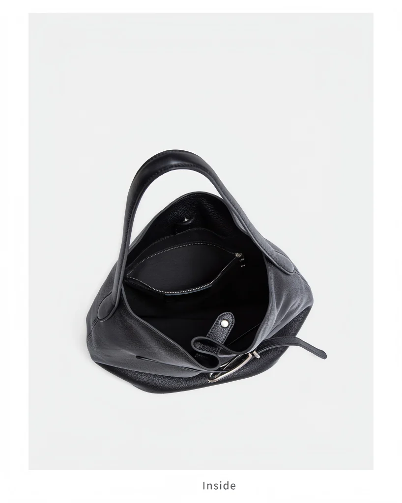 Close-up shot of the adjustable shoulder strap hardware on Lock-Top Bucket Bag, genuine top-grain cowhide leather