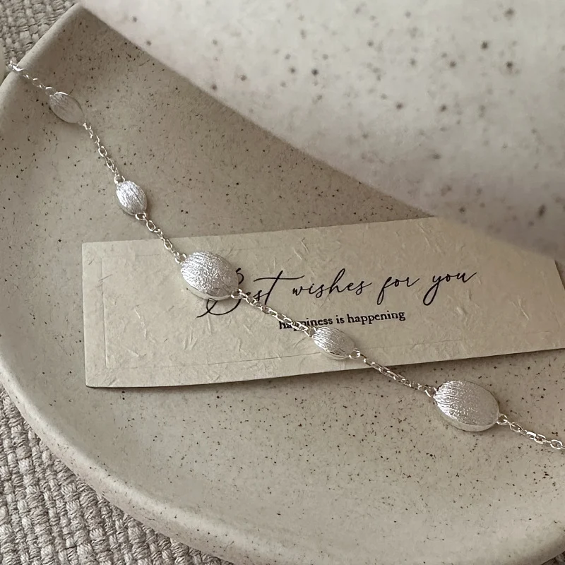 Close-up of the brushed matte texture and irregular links on the S925 sterling silver bracelet