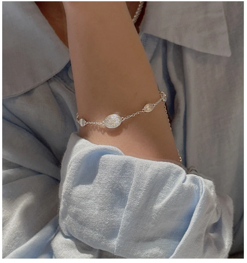 Model wearing the S925 sterling silver brushed minimalist bracelet on her wrist
