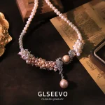 Close‑up view of flower vine pearl cluster and drop pearl pendant on vintage zircon choker necklace