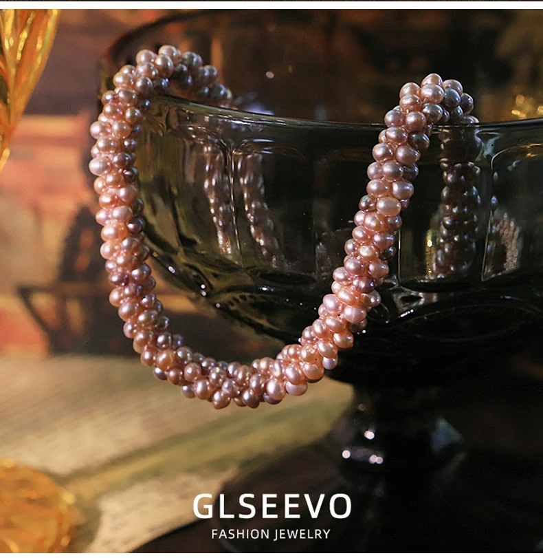 Close-up lifestyle shot showing the twisted purple freshwater pearl necklace worn on a woman's neck, demonstrating the elegant fit and luster of the handmade pearl jewelry