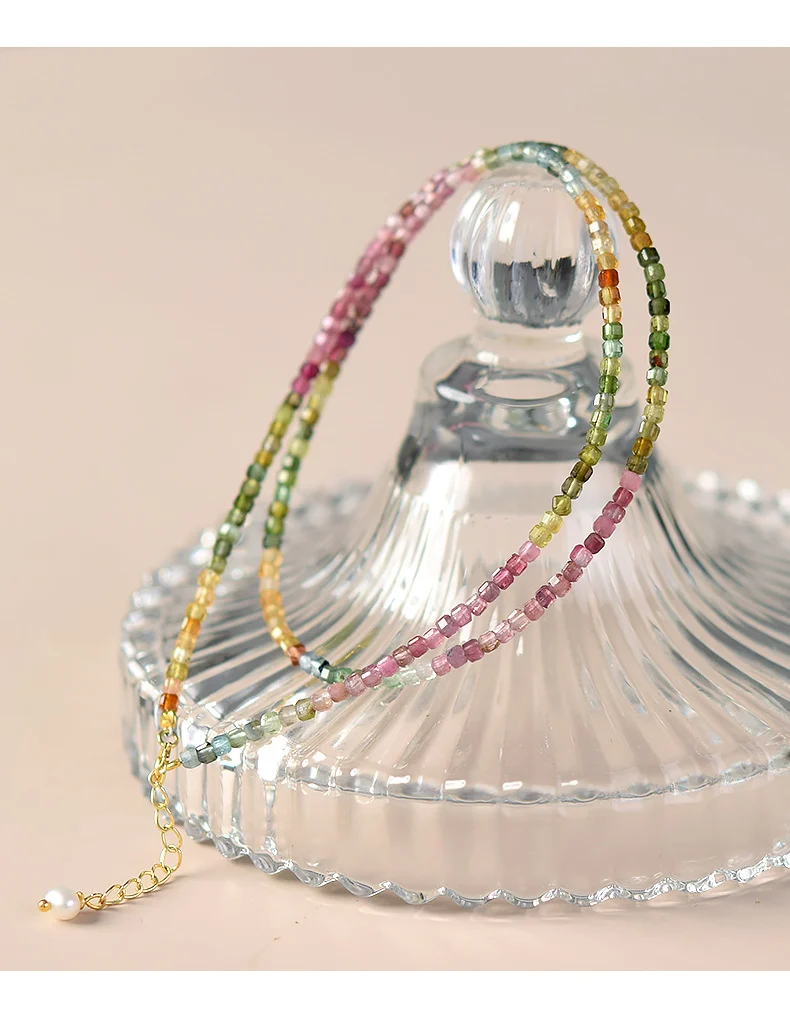 Flat lay lifestyle shot of rainbow tourmaline beaded choker on book page