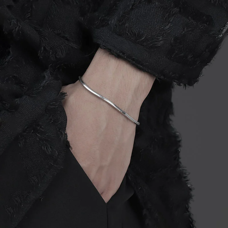 Model wearing dainty octagonal snake bone 925 sterling silver bracelet on wrist, minimalist everyday silver jewelry