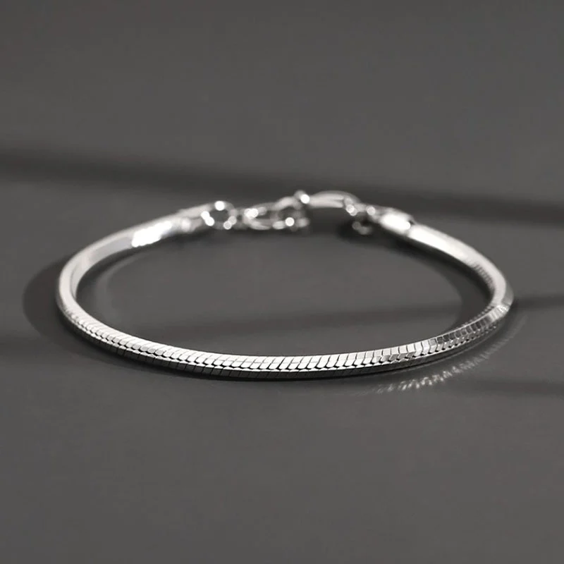 Close-up macro shot of octagonal snake bone 925 sterling silver bracelet, showing fine chain texture and clasp details