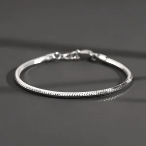 S925 sterling silver octagonal snake chain bracelet studio shot on dark grey background