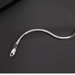 Close‑up shot of S925 sterling silver octagonal snake chain bracelet showing lobster claw clasp