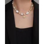Woman model wearing french vintage baroque freshwater pearl choker necklace with zircon pendant
