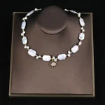 Close‑up shot of baroque freshwater pearl necklace displayed on brown jewelry tray