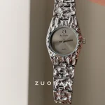 Close-up view of Bee Sister hammered silver watch, irregular textured case and sunburst dial with crystal decoration