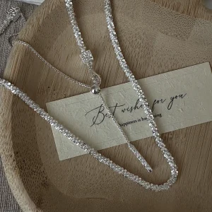S925 sterling silver sparkle crushed bead Y lariat necklace flat lay on wooden tray with best wishes greeting card