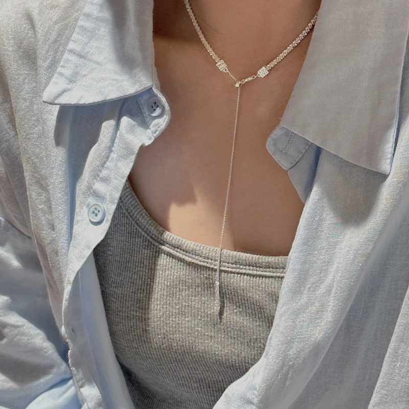 Adjustable S925 sterling silver Y lariat necklace worn in long drop style with linen shirt and gray camisole, elegant Y shape