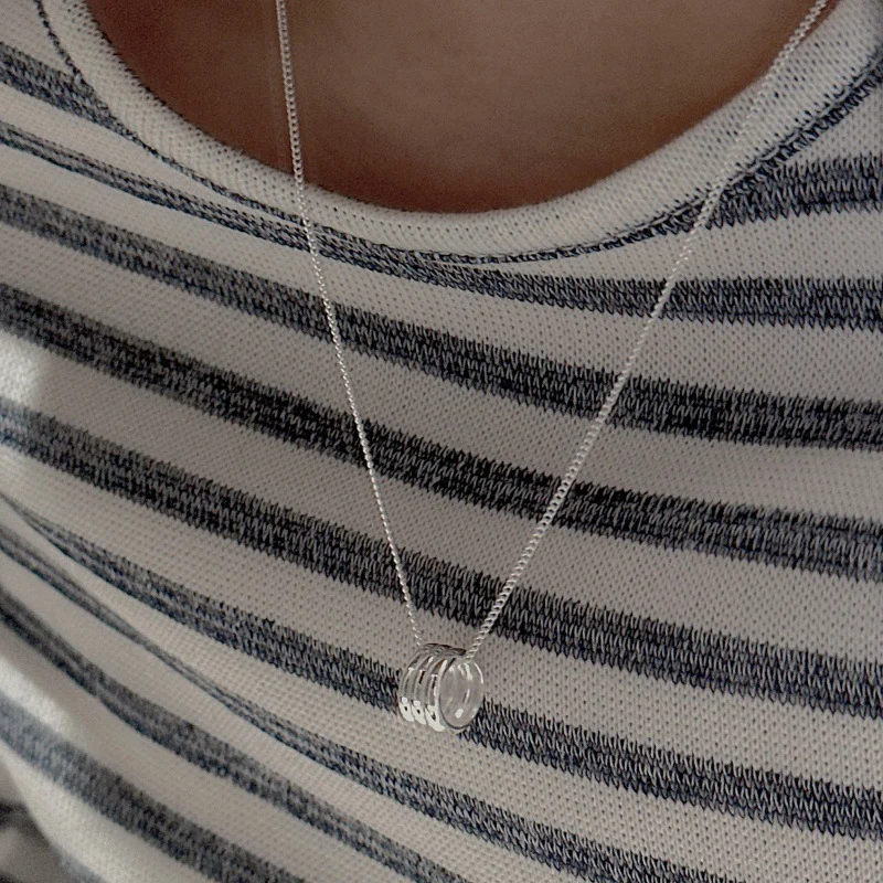 S925 sterling silver multi stacked ring pendant necklace worn on collarbone with striped knit sweater, minimalist silver necklace for women