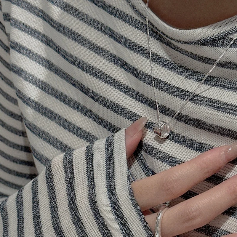 Side wearing view of S925 multi stacked ring silver necklace paired with striped casual top, minimalist collarbone styling