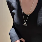 S925 silver ball chain teardrop crystal necklace worn on collarbone with black V-neck knit sweater