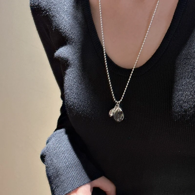 S925 silver ball chain teardrop crystal necklace worn on collarbone with black V-neck knit sweater