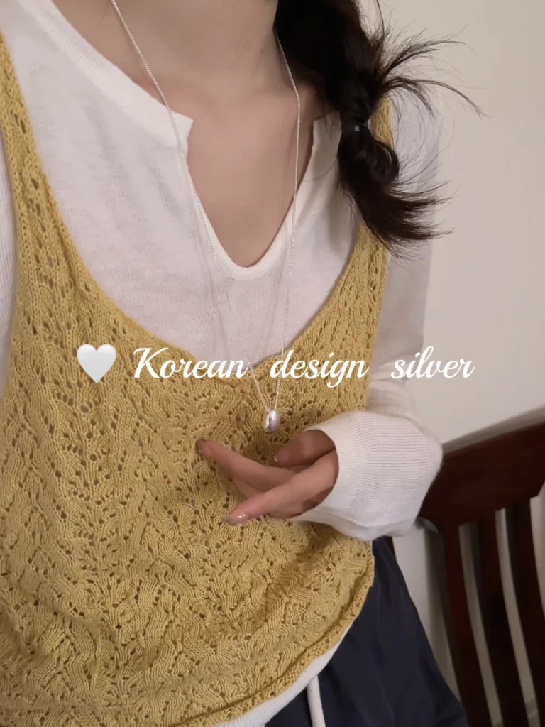 S925 sterling silver bean pendant necklace worn with yellow knit camisole and white inner top, daily Korean outfit