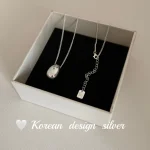 S925 sterling silver oval bean pendant necklace displayed in white jewelry gift box
