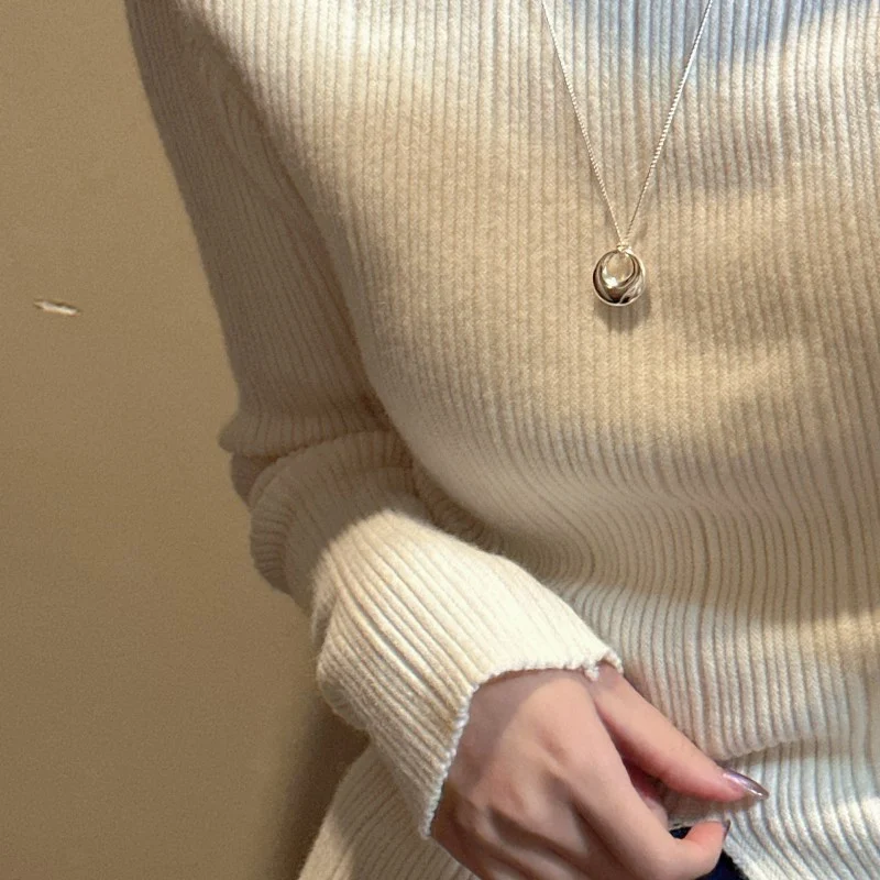 S925 hollow donut pendant necklace worn with cream ribbed knit sweater, sweater chain wearing view